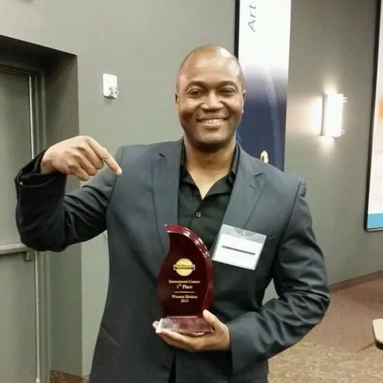 Patrick Meniboon, holding a speaking award